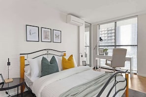 The 2nd bedroom on level 1 with a double sized bed & plush pillows.