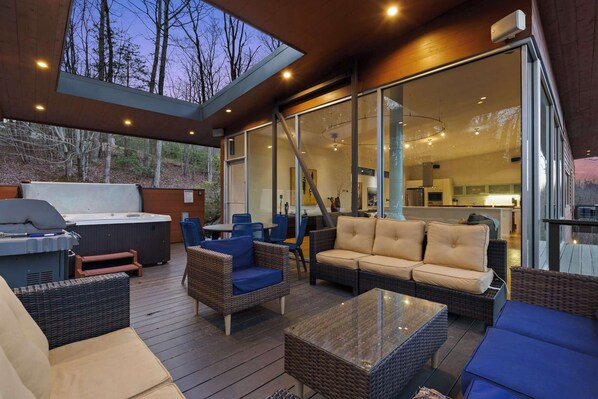 Relax in this stunning outdoor lounge with a cozy seating area, hot tub, and breathtaking views! 