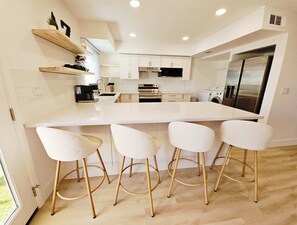 The airy, open kitchen offers ample space & every home comfort