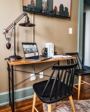 [Workspace] A modern, inviting workspace with a comfortable chair, well-arranged tools, and a warm, minimalist design to enhance work performance