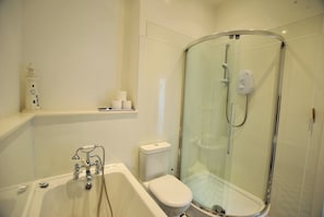 The bathroom benefits from a bath and separate shower