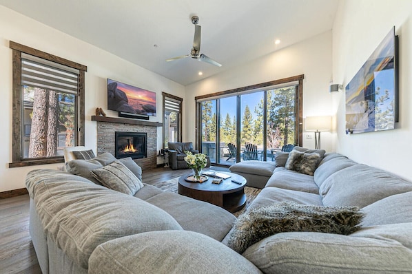 Relaxing living room with "cloud" sectional, surround sound TV and fireplace
