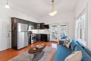 Open concept living room/kitchen with french doors out to the covered porch.