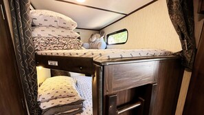 Spacious private bunk beds feature privacy curtains, USB ports and natural light