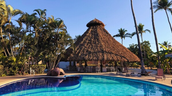 Enjoy the on-site pool and palapa for a perfect relaxation spot.