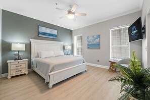 Relax in the serene master suite featuring a king bed, calming coastal colors, and plenty of natural light.