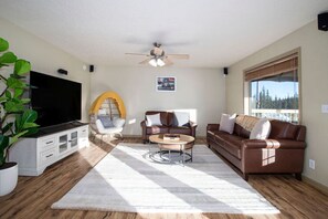 Main living room with big window start tv and egg chair