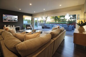 Seamless indoor-outdoor living, the living room features stunning folding glass.