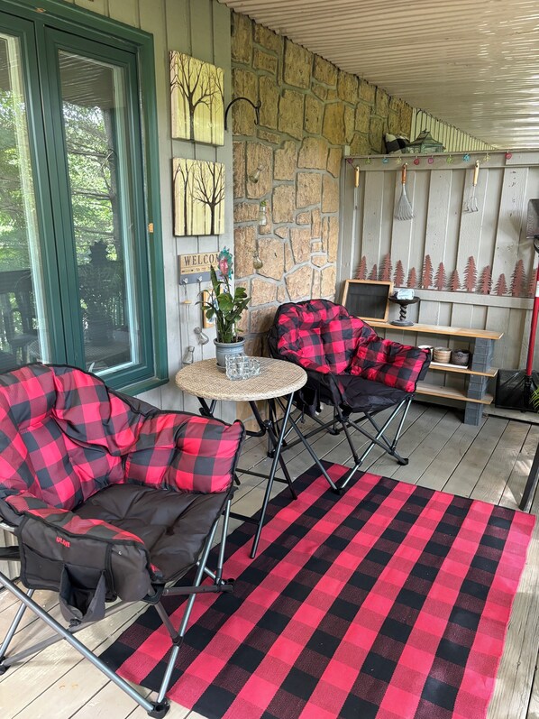 Comfy Chairs and a Mtn Theme make this porch a great place to relax.