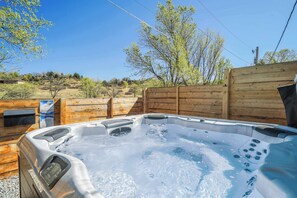 Indulge in the Hot Tub, Bathed in Glorious Sunlight! Rejuvenate and Relax, Setting the Stage for an Energized and Refreshing Vacation Experience..