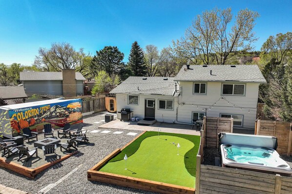 Welcome to Tonka Estate – your Colorado Springs retreat! Unwind in the stunning backyard oasis featuring a hot tub, putting green, BBQ, fire pit, and vibrant mural – perfect for relaxation and fun!