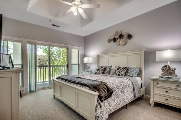 Spacious king suite with private balcony access and a dreamy view of the golf course