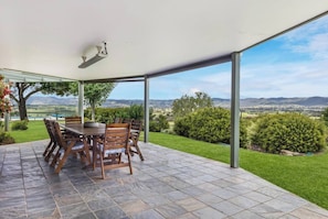 Dine alfresco beneath open skies at the long timber table, warm the evenings with the outdoor heater, and let conversation linger as the sun sets.