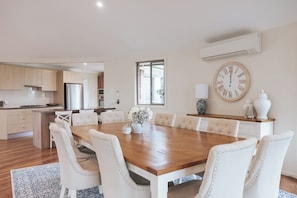 Gather for laughter-filled meals around the elegant ten-seater dining table, kept perfectly comfortable with reverse cycle air conditioning.