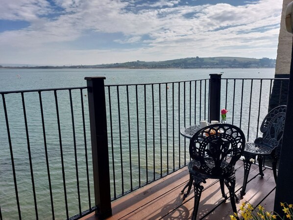 Shoreline Balcony And Seating Area With Coastal View