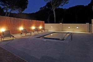 This inviting pool, glowing under the night sky, promises relaxation and rejuvenation. Surrounded by the subtle light and gentle rustling of leaves, the spacious patio creates an intimate escape perfect for enjoying quiet evenings.