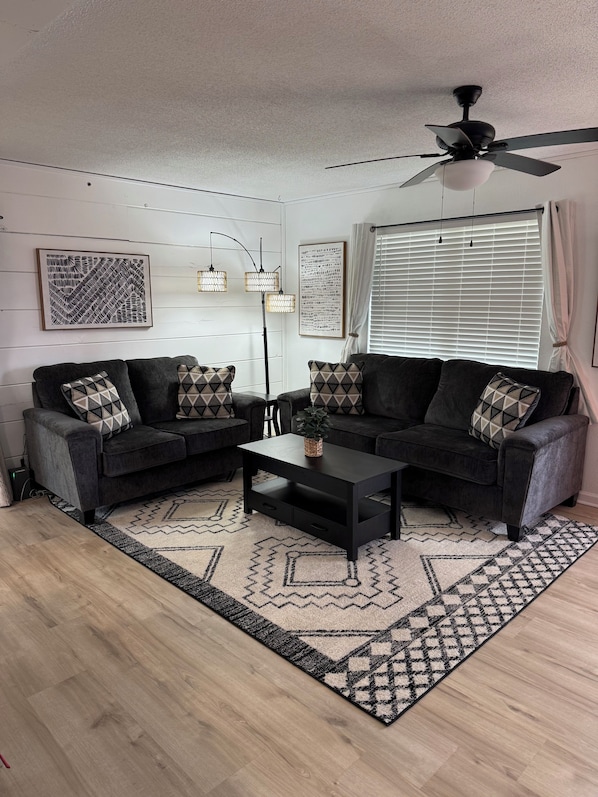Large comfortable living room with flat screen TV.