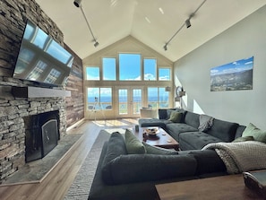 The Living Room has beautiful views, a huge sectional and two chairs, & 86" TV