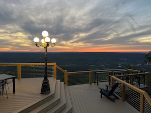 The Deck includes a dining table and chairs, bar table and chairs, & adirondacks