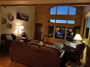 Cozy living room with gas fireplace and stunning view of the river.