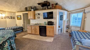 Kitchenette area-counter, sink, mini fridge, microwave, dishes