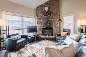 Cozy and open living room with fireplace and large windows