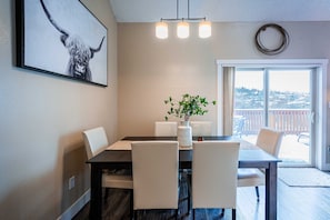 Dining room which opens to kitchen, living room and exit to large deck