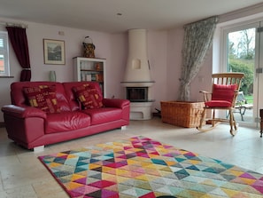 Living room with wood burning stove and bi-fold doors out on to the garden