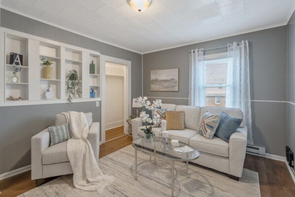 Step into a warm and inviting living space, designed for comfort and connection