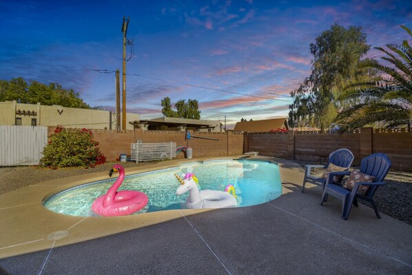 Pool with floaties twilight