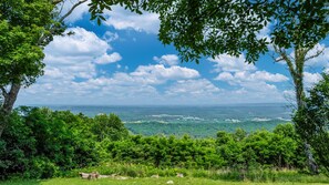 Breathtaking mountain views stretch for miles from the brow of this mid-century cottage.