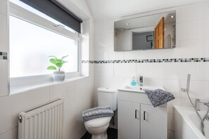 The main full bathroom is ensuite in Bedroom 2.
- Sink
- Toilet
- Electric Shower-over-Bath

There is a WC downstairs.