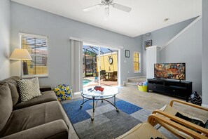 Relax in a clean, spacious living area just steps from your private pool. With large windows bringing in natural light and easy access to the outdoor space, it's the perfect spot to unwind after a swim or enjoy quality time with family and friends.