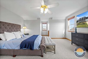 Spacious bedroom with a king-size bed and soft linens.