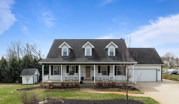 Charming home with a big driveway and welcoming porch.