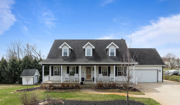 Charming home with a big driveway and welcoming porch.