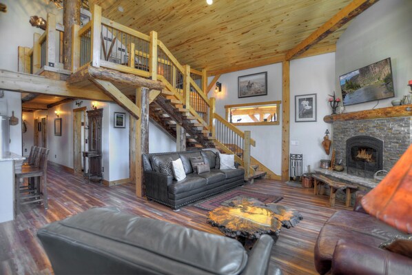Gather, relax, and stay warm in this beautiful living room with a fireplace