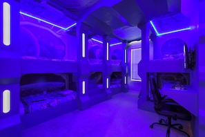 Epic space-themed bunk room with glowing lights and galactic vibes!