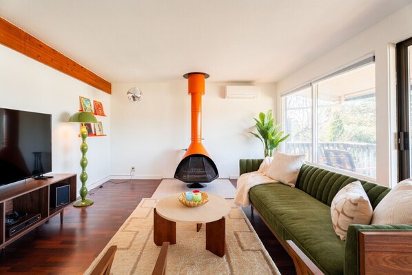 Aesthetic and airy living room featuring a record player for the ultimate retro experience.