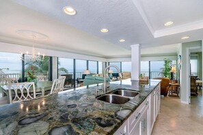 Open Kitchen, dining, and living - Open kitchen, dining, and living room with amazing floor to ceiling panoramic ocean view!