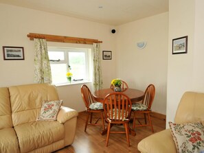 Dining table with seating for four. Sofas