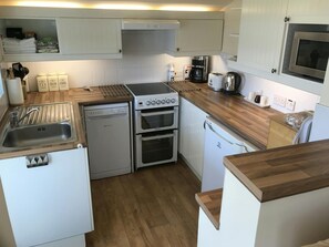Kitchen with cooker, sink, coffee maker