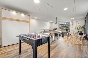 Game room with a foosball table, ping pong table, board games, a projector screen with ROKU device with mountain & lake views.