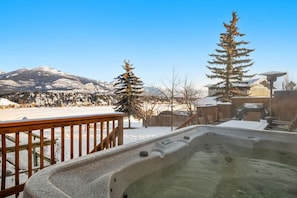 Private hot tub on the backyard deck with mountain & lake views.