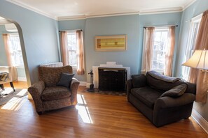 Spacious and bright living room with working fireplace