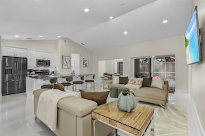 The Living Room, Kitchen and Dining Room all share the same bright and inviting open concept space