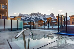 Soak in the outdoor hot tub with sweeping mountain views—just steps away from your condo.