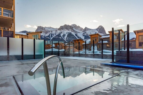 Soak in the outdoor hot tub with sweeping mountain views—just steps away from your condo.
