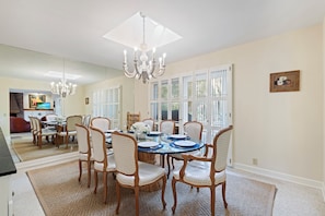 Fully equipped kitchen with stainless appliances and a modern dining room seating 8