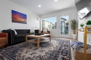 Well apportioned living room and balcony with views of the San Diego bay.